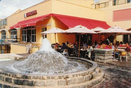 Foldarm_awnings_with_pelmets_and_umbrellas_Europa_Village_Walk