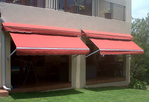 Retractable drop arm awning